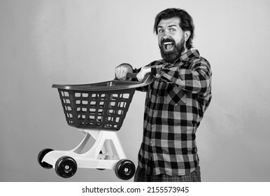 cyber monday. bearded hipster hurry for big sale. concept of black friday. shopaholic. happy man go shopping. cheerful man carry shopping cart. masculinity and charisma