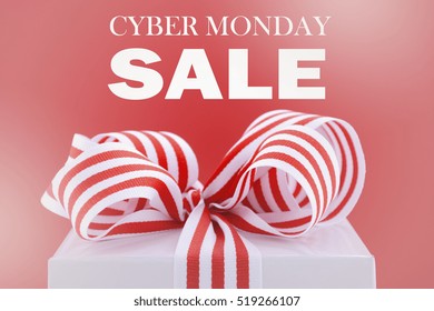 Cyber Monday red and white sales promotion gift box closeup against a red background, with applied faded filters. 