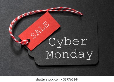 Cyber Monday Sale Text On A Black Tag With A Red And White Twine