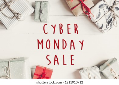 Cyber monday sale text. Wrapped present boxes on white wooden background top view. Seasonal greetings. Black friday sale