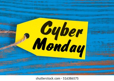 Cyber Monday sales tag. Yellow color tags on blue wooden background
