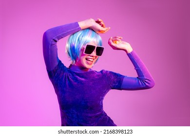 Cyber Punk Girl Concept, Asian Woman In Purple Sweatshirt Blue Color Short Hair Style Wearing Sunglasses Posing Dancing On The Pink Purple Screen Background. 