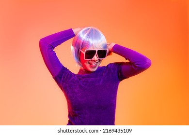 Cyber Punk Girl Concept, Asian Woman In Purple Sweatshirt Silver And Blue Short Hair Style Wearing Sunglasses Posing Dancing Like Robot. 