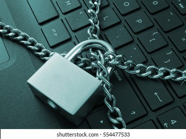 Cyber safety concept, locked chain on laptop computer keyboard 