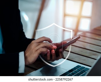Cyber secure system technology, network device security, privacy digital data protection concepts. Safety shield and padlock icons appears covering while business person using smart mobile phone.