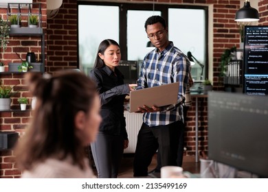 Cyber security agency employees using laptop to monitoring internet bandwidth and database used storage. Software developers analyzing received encrypted files by scanning them for malware.