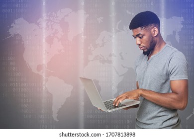 Cyber Security Concept. African american hacker using laptop on world map digital background