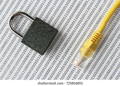 A cyber security concept image consisting of a padlock, binary code background and an Ethernet cable. This image has selective focusing. 