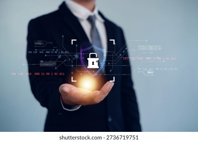 Cyber security and data protection concept with digital shield and lock icon above businessman hand, representing information security, privacy protection, secure systems, and network technology.