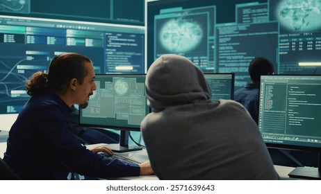 Cyber security experts in a governmental hacking room working on securing networks. Hackers focusing on malware detection, cyber operations and protection against digital mercenaries. Camera B.