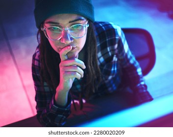 Cyber security, focus and woman hacker working on a computer in the basement at night for phishing. Database, password and ransomware with a female coder hacking a digital transformation network - Powered by Shutterstock