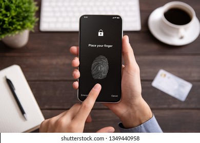 Cyber security of personal device. Man using modern cellphone with application for scanning fingerprint, isolated on white background