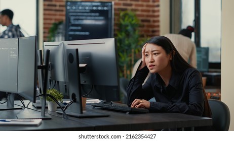 Cyber security programer focused on writing code encounters system failure while parsing algorithm sitting at desk. System engineer having unexpected compiling error while creating software.