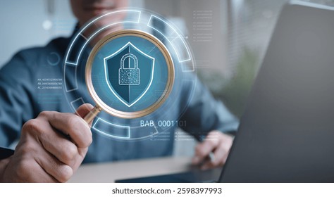 Cyber security system technology. Secure information privacy. Crime network technology. A man is holding a magnifying glass over a computer screen that has a security symbol on it. - Powered by Shutterstock - Get 15% off with code: PIKWIZARD15