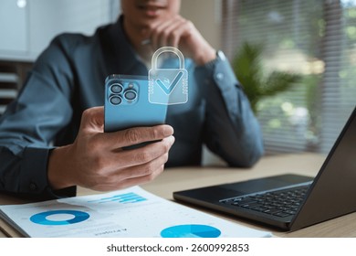 Cyber security system technology. Secure information privacy. Crime network technology. A man is holding a cell phone with a security lock icon on it. Concept of protecting one's personal information.