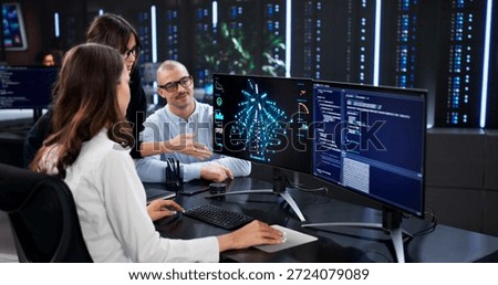 The Cyber Security Team Analyzing Data On Center's Main Screen.
