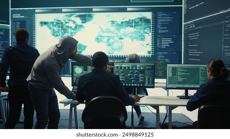 Cyber security team conducting cyber surveillance and threat detection in a governmental agency. Hackers working on cybercrime and malware prevention, data breach protection. Camera B.