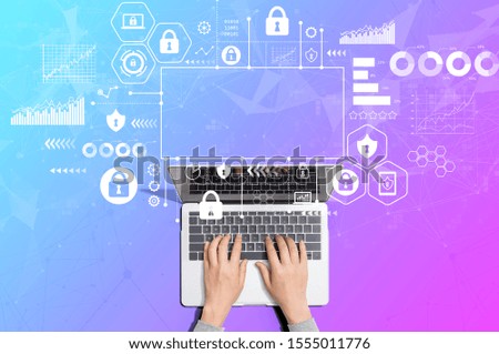 Cyber security theme with person using a laptop computer