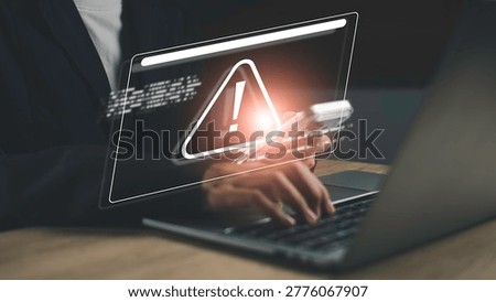 Cyber security warning alert on smartphone and laptop screen. Online scam, phishing attack, data breach risk, and digital threat protection concept for secure internet usage and information safety.