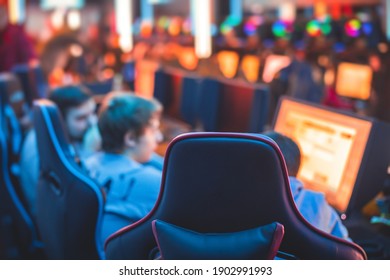 Cyber sport e-sports tournament, team of professional gamers, close-up on gamer's hands on a keyboard, pushing button, gamers playing in competitive moba, strategy fps game in a cyber games arena club