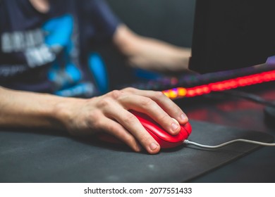 Cyber sport e-sports tournament, team of professional gamers, close-up on gamer's hands on a keyboard and mouse, gamers playing in competitive moba, strategy fps game in a cyber games arena club