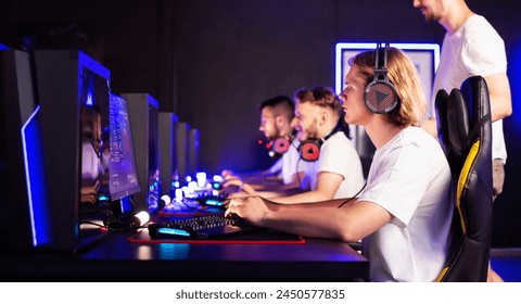 Cyber sport tournament at computer club E-sport championship. Fingers press keys on gaming keyboard close up. Left-handed team gamer plays video game on PC. - Powered by Shutterstock