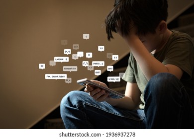 Cyberbullying - Social Media Harassment Concept. Young Asian Preteen, Teenager Boy Looking At His Smartphone Feeling Frustrated After Reading Bad Comments. Text Emoticons. Bully, Teen Mental Health