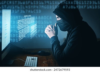 Cybercrime, hacker and thinking at computer for virus, overlay and futuristic at desk. Male criminal, hoodie and ready for coding, cyber attack and programming for malware with tech, scam and data - Powered by Shutterstock