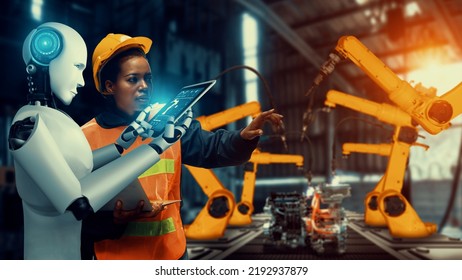 Cybernated industry robot and human worker working together in future factory . Concept of artificial intelligence for industrial revolution and automation manufacturing process . - Shutterstock ID 2192937879