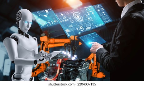Cybernated industry robot and human worker working together in future factory . Concept of artificial intelligence for industrial revolution and automation manufacturing process . - Shutterstock ID 2204007135