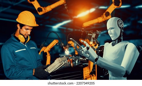 Cybernated industry robot and human worker working together in future factory . Concept of artificial intelligence for industrial revolution and automation manufacturing process . - Shutterstock ID 2207349205