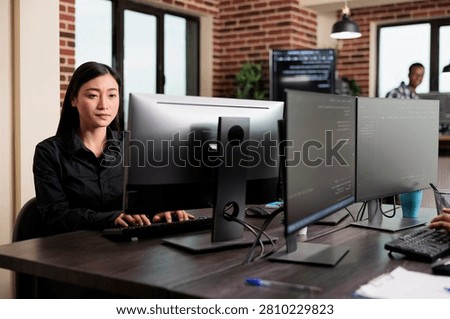 Cybernetics engineer securing mainframe database storage Cybernetics engineer writing lines of code in order to secure mainframe database storage.