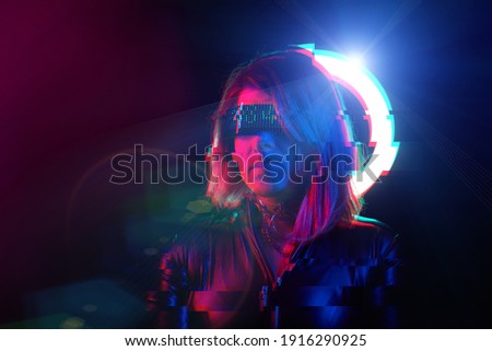 Cyberpunk style portrait of beautiful young woman in futuristic costume. Image with glitch effect. Concept of augmented and virtual reality, game, future technology.