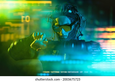 A cyberpunk warrior of the future controls a digital hologram. Game, virtual reality. Future technologies. - Shutterstock ID 2003675723