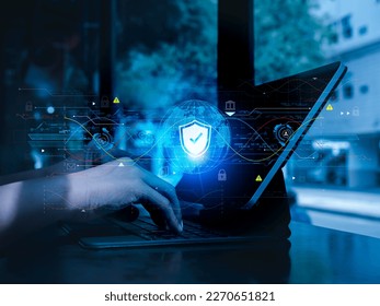 Cybersecure, worldwide internet network security technology, privacy digital data protection concepts. Safety shield icon hologram appears while person work with digital tablet computer, blue tone.