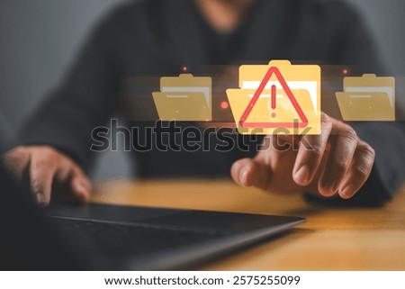 Cybersecurity alert with digital file folder. hand interacting with a cybersecurity alert symbol. virus, spyware, malicious software, malware, or cyberattacks on computer networks.