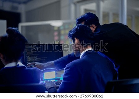 Cybersecurity analysts executing threat mitigation protocols in security operations center. IT specialists monitoring network firewall intrusion detection.