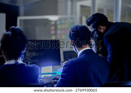 Cybersecurity analysts executing threat mitigation protocols in security operations center. IT specialists monitoring network firewall intrusion detection.