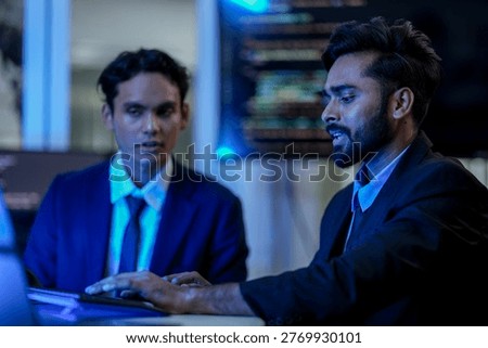 Cybersecurity analysts executing threat mitigation protocols in security operations center. IT specialists monitoring network firewall intrusion detection systems.