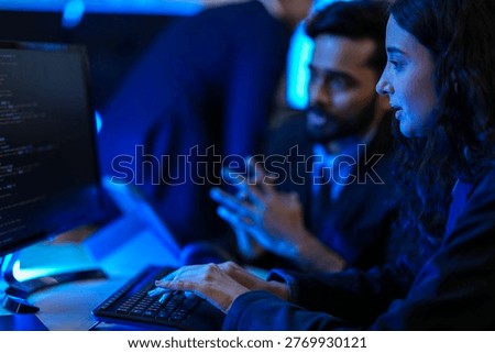 Cybersecurity analysts executing threat mitigation protocols in security operations center. IT specialists monitoring network firewall intrusion detection systems.