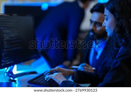 Cybersecurity analysts executing threat mitigation protocols in security operations center. IT specialists monitoring network firewall intrusion detection systems.