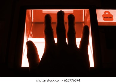 cybersecurity concept - person unlocks a computer on a divice with his fingerprints