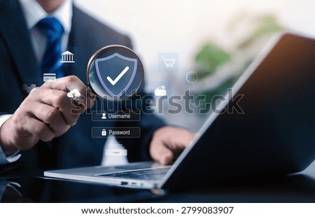 Cybersecurity and data protection concept featuring a business professional using a magnifying glass to verify secure login access. Online privacy authentication digital security, identity protection.