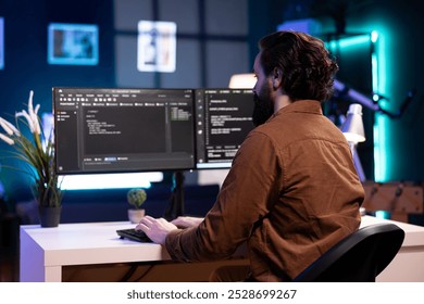 Cybersecurity expert using computer to look for company security vulnerabilities and injected malware. Programmer installing fortified code on PC to prevent cyber attacks - Powered by Shutterstock