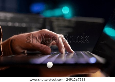 Cybersecurity expert using laptop to look for company security vulnerabilities and prevent malware infections. Developer installing fortified code on notebook to prevent cyberattacks, close up shot
