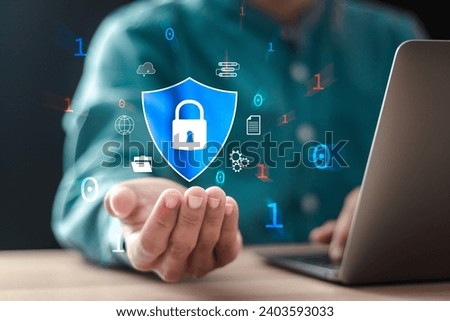 Cybersecurity and privacy concept to protect data. Businessman use computer laptop with shield and padlock icon for protecting personal data and cyber security.
