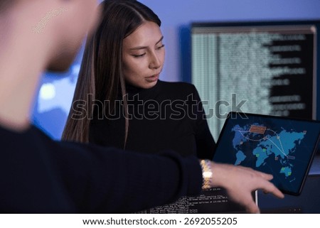 Cybersecurity professionals collaborating on real-time threat analysis in a SOC environment