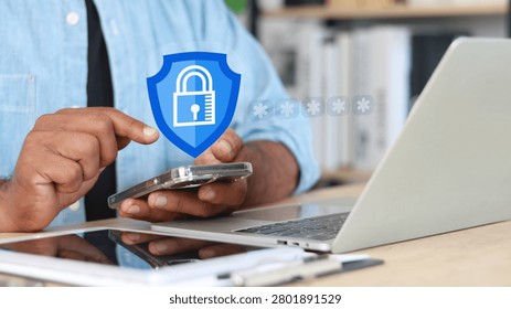 Cybersecurity protection concept with user accessing smartphone and laptop secured by digital shield and padlock icon. Mobile security, password authentication, data privacy, cyber defense and online protection.