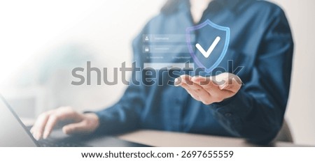 cybersecurity, security, privacy, encryption, Close-up of a person using a laptop with a holographic shield icon, symbolizing cybersecurity, data protection, and secure authentication access.