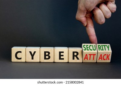 Cyber-security vs cyber-attack symbol. Businessman turns wooden cubes, changes words Cyber-attack to cyber-security. Beautiful grey background. Cyber-security vs cyber-attack concept. Copy space. - Shutterstock ID 2158002841